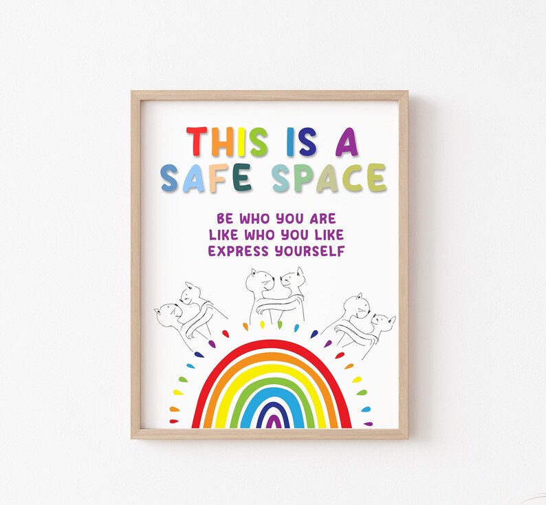 May include: A colorful poster with the text "This is a Safe Space" and the words "Be who you are, Like who you like, Express yourself". The poster features a rainbow and three cartoon figures hugging.