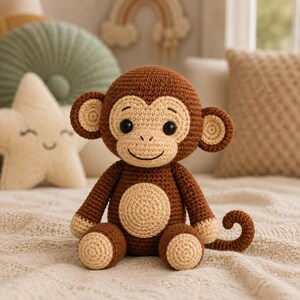 May include: A brown and beige crocheted monkey toy with large round ears, a circular belly patch, and a curled tail. The monkey has black plastic eyes and a stitched smile, crafted with a textured yarn finish in a seated position.