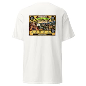 May include: A white short-sleeve t-shirt featuring a large rectangular graphic on the back. The graphic displays a cartoon character in a cowboy hat, wildlife imagery, and text including "Dicky Fiddles Sub Sonic Wildlife Calls" and "Call Nature. Not Attention. Common Sense... Sold Separately."