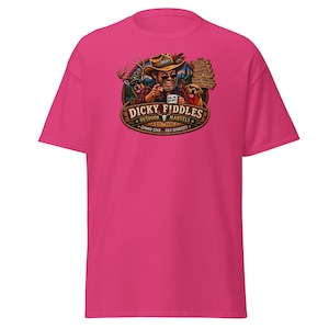 May include: A bright pink short-sleeve t-shirt featuring a graphic of a person in a hat pointing forward, accompanied by a deer and a dog. The text reads Dicky Fiddles Outdoor Marvels, Est. 2026, Common Sense Sold Separately, and other phrases.