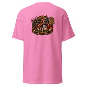 May include: A bright pink short-sleeve t-shirt featuring a graphic on the back. The design shows a man in a hat pointing forward, a deer, a dog, and text that reads Dicky Fiddles Outdoor Marvels Est. 2026, Common Sense... Sold Separately.