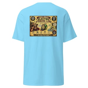 May include: A light blue t-shirt featuring a graphic on the back with the text 'Dicky Fiddles Electric Fishing Line'. The illustration depicts a person in a hat, a fishing reel, and a jumping fish, surrounded by various fishing-related text.