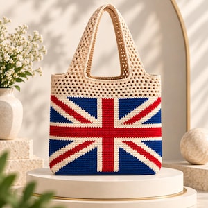 May include: A crochet tote bag featuring a prominent Union Jack flag design in red, white, and blue. The upper portion of the bag is crafted with an open-work cream-coloured crochet pattern, while the lower section displays the flag motif.