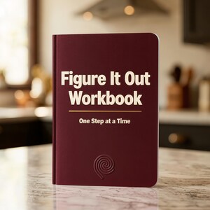 Puede incluir: Un libro de ejercicios de color granate oscuro con tapa dura. La portada presenta el texto "Figure It Out Workbook" en letras grandes de color crema, seguido de una línea horizontal y el texto "One Step at a Time". Un icono de espiral está grabado.