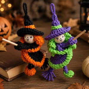 May include: Two handmade crochet witch ornaments with wooden bead faces. One witch wears a black and orange outfit with a matching hat, while the other wears a purple and lime green outfit with a matching hat. Both figures hold a small wooden broomstick.