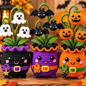 May include: Three crocheted Halloween-themed pots with smiling faces. The left pot is black with white ghosts, the middle is purple with black bats, and the right is orange with jack-o'-lanterns. Each pot features green leaves and a belt.