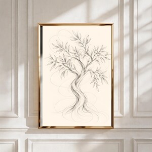 May include: A framed wall art print featuring a fine-line charcoal sketch of a twisted olive tree with delicate, elongated leaves and exposed roots, set against a solid cream-coloured background within a thin, metallic gold-toned frame.