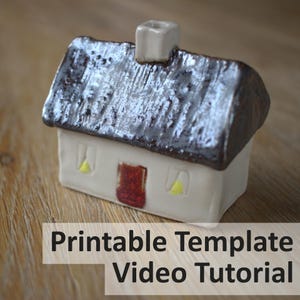 May include: A small ceramic house figurine with a cream-colored base, a dark brown textured roof, a central chimney, a red door, and two yellow windows. The text "Printable Template Video Tutorial" is overlaid at the bottom of the image.