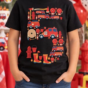 May include: A black short-sleeve t-shirt featuring a large graphic of the number five composed of various firefighting equipment including red fire trucks, fire hydrants, axes, fire hoses, alarm bells, buckets, and yellow and red boots.