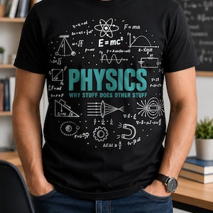 May include: A black short-sleeved t-shirt featuring a white graphic print of various physics equations, diagrams, and symbols. The center displays the word PHYSICS in large teal letters above the text WHY STUFF DOES OTHER STUFF in smaller teal.