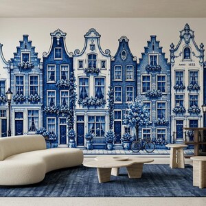 May include: A wall mural featuring a repeating pattern of blue and white Dutch canal houses with intricate architectural details, windows, and floral accents. The text ANNO 1652 is visible on the facade of one of the buildings in the mural.