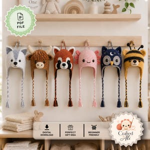 May include: Six crocheted animal hats hanging on a wooden rack. The hats feature designs of a grey wolf, a brown highland cow, a red panda, a pink axolotl, a dark blue owl with a moon, and a yellow and black bee, each with braided earflaps.