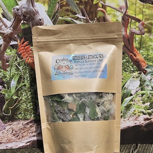 May include: A brown paper pouch containing a mix of dried leaves, bark, and organic materials. The label reads Crabitat Baddies Baddies Bark & Botanical Pack Premium Substrate Litter, listing ingredients like Indian Almond Leaves, Oak Bark, and Mulberry Leaves.