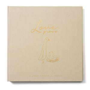 May include: A beige journal with the words "Love grows" in gold script. Below the text is a gold illustration of a goose and a baby goose in a nest. The text "A simple pregnancy journal" is at the bottom.