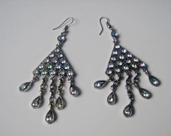 Vintage metal earrings with faceted glittering reflecting light