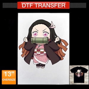 May include: A DTF transfer featuring a chibi-style anime character with long black hair, pink eyes, and a green bamboo muzzle. The character wears a pink patterned kimono with a dark brown outer robe. A 13-inch label is visible on the graphic.