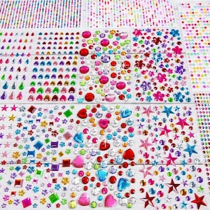 May include: A collection of adhesive rhinestone sticker sheets featuring various shapes including circles, hearts, stars, flowers, and teardrops in a wide array of vibrant colours such as red, blue, green, pink, yellow, and purple with a glossy finish.