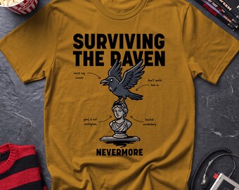 May include: A mustard yellow t-shirt featuring a black graphic of a raven perched on a classical bust. The text reads "SURVIVING THE RAVEN" and "NEVERMORE," with smaller labels pointing to the raven and bust stating "never say Lenore," "don't invite him in," "grief is not contagious," and "limited vocabulary."