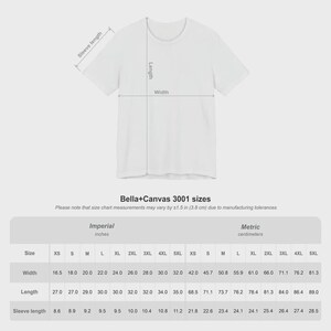 May include: A white t-shirt with a size chart overlay showing measurements for Bella+Canvas 3001 sizes. The chart lists width, length, and sleeve length in inches from XS to 5XL, noting a manufacturing tolerance of plus or minus 1.5 inches.