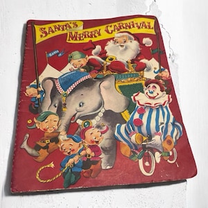 May include: A vintage children's book cover featuring Santa Claus riding an elephant with a clown and elves. The cover is red with the title "Santa's Merry Carnival" in white letters.