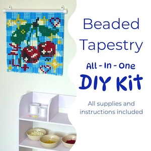 May include: A beaded tapestry DIY kit featuring a finished wall hanging of two red cherries on a blue background, a white shelf with bowls of colored beads, and text that reads Beaded Tapestry All-In-One DIY Kit All supplies and instructions included.