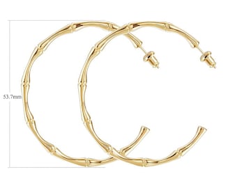 May include: A pair of gold bamboo hoop earrings. The earrings are 53.7 mm in diameter and weigh 11 grams.