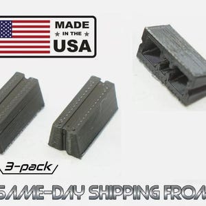 May include: Three small, rectangular, black plastic components with a textured, layered surface and a central groove. The items are presented as a 3-pack, accompanied by a graphic featuring the American flag and the text MADE IN THE USA.