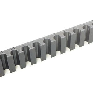 May include: A dark gray, rectangular storage rack featuring a series of twelve vertical, U-shaped slots designed for holding cylindrical items. The top surface of the rack displays small, printed numbers ranging from one to twelve above each slot.