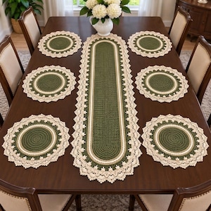 May include: A set of six round crochet placemats and one long oval crochet table runner. Each piece features a dark olive green center, a thin beige ring, and a wide cream-colored scalloped lace border with intricate decorative edging.