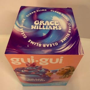 May include: A rectangular product box for a Grace Williams clear slime kit. The top features a swirling purple and blue design with the text Clear Slime. The front is orange with the text gui-gui and an illustration of a slime container.