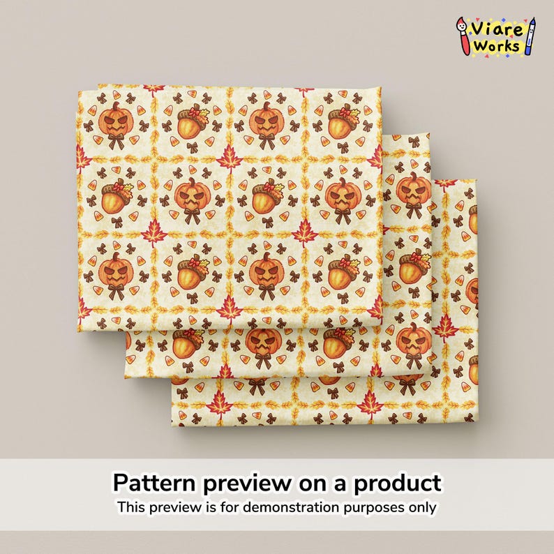 May include: A fabric swatch featuring a repeating autumn pattern on a cream background. The design includes orange jack-o'-lanterns, brown acorns, red maple leaves, and small candy corn icons arranged within a grid of golden wheat stalks.
