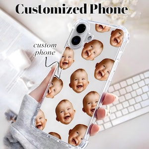 May include: A clear, transparent phone case featuring a repeating pattern of a smiling baby's face printed across the surface. The case includes reinforced corners and cutouts for the camera lens and flash, with the text custom phone visible.