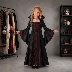 May include: A floor-length black dress with long flared sleeves and a high collar. The bodice features a dark red floral pattern, a lace-up corset-style front, and a deep red lining on the sleeves. A silver-toned choker necklace is worn at the neck.