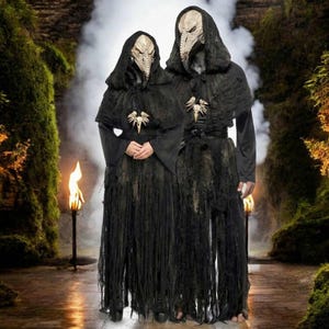 May include: Two black hooded robes with tattered, fringed hemlines and long sleeves. Each robe features a beige, textured bird-like skull mask with a pointed beak and a decorative bone-colored bird skull pendant centered on the chest area.