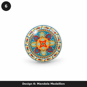 May include: A round ceramic knob featuring a vibrant mandala medallion design. The pattern displays a central red star on a yellow background, surrounded by blue and red floral motifs, with a border of small red and yellow flowers on a white base.