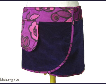 May include: A purple skirt with a pink floral print waistband and a large pocket on the front.