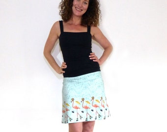 Waistband skirt Flamingo in A-shape - lime, white with flamingos on roller skates ORGANIC