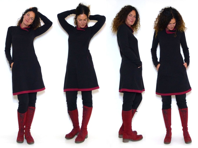 Puede incluir: Un vestido negro con ribete burdeos y mangas largas. El vestido est&aacute; ajustado a la cintura y se ensancha en el dobladillo. La modelo lleva leggings negros y botas burdeos.