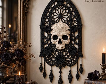 May include: A black crocheted wall hanging featuring an arched gothic window frame design with a central cream-colored skull and several crocheted roses. The piece includes dangling decorative elements at the bottom and the text HoneyHookPattern.