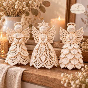 May include: Three cream-colored crochet angel figurines with intricate lace-like patterns, delicate wings, and small white bead accents. Each angel features a distinct dress design, including layered petals and openwork stitching, standing upright.