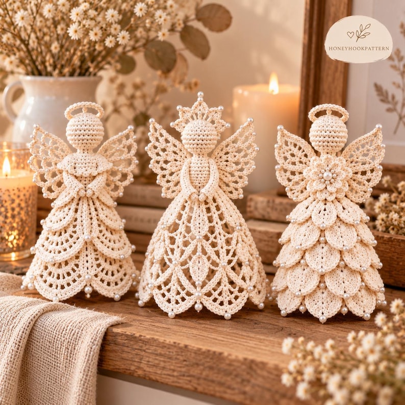 May include: Three cream-colored crochet angel figurines with intricate lace-like patterns, delicate wings, and small white bead accents. Each angel features a distinct dress design, including layered petals and openwork stitching, standing upright.