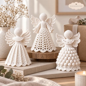 May include: Three off-white crochet angel figurines with distinct stitch patterns. The left angel has a pleated skirt, the center angel features a lacy openwork design, and the right angel displays a textured bobble stitch pattern with small beads.