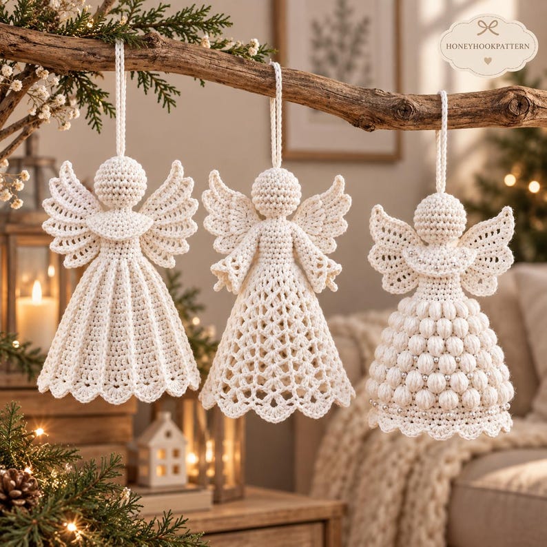 May include: Three off-white crochet angel ornaments hanging from a wooden branch. Each angel features a round head, spread wings, and a unique dress texture: one with vertical pleats, one with a lattice pattern, and one with a bobble stitch design.