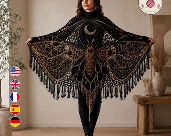 May include: A black crochet shawl featuring a large moth design with intricate wing patterns in shades of brown and tan. The garment has a crescent moon motif at the neckline and is finished with long fringe along the bottom edge.