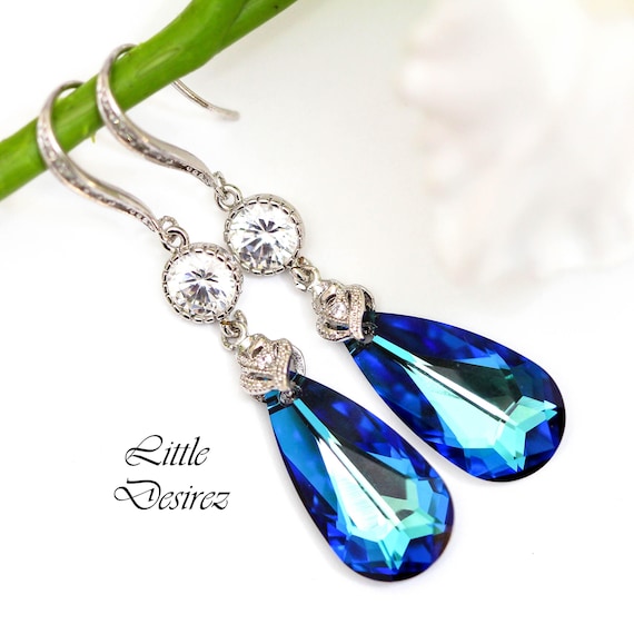 PAVEL'S - Pendientes Para Mujer Con Un Cristal Azul Verde Rodeado De Cristales Brillantes De Color Blanco, Incluye Una Elegante Caja De Regalo Y Bolsa De Brillo