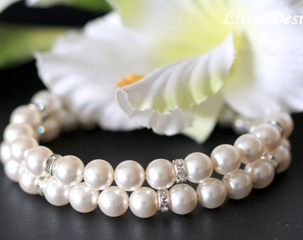 May include: A double strand pearl bracelet with small clear rhinestones on the silver clasps.