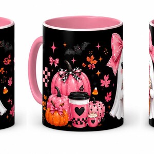 May include: A black ceramic mug with a pink interior and handle, featuring a graphic of a white ghost wearing a pink bow, holding a coffee cup, surrounded by pink and orange pumpkins, autumn leaves, bats, and the text BOO BREW in pink and orange.