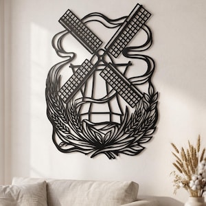 Puede incluir: Una pieza de arte mural de metal negro que presenta la silueta detallada de un molino de viento tradicional con cuatro aspas grandes, rodeada de líneas fluidas estilizadas y una base decorativa de tallos de trigo en patrón curvo.
