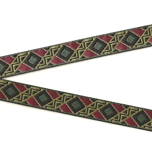 May include: Green, red, and gold patterned trim with a geometric design. The trim is woven and has a subtle sheen.