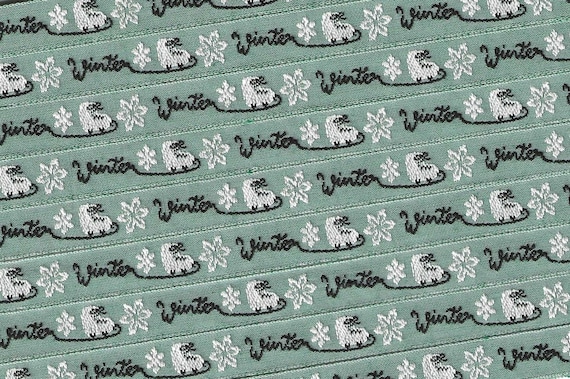 KAFKA A-18/02 Jacquard Ribbon Woven Organic Cotton Trim 7/16" wide (10mm) Sage Green Background w/White Ice Skates and Black "WINTER" Words
